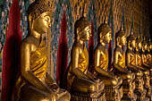 Bangkok Wat Arun - The covered passageway around the ubosot is lined with 120 Buddha statues in the sitting position.  